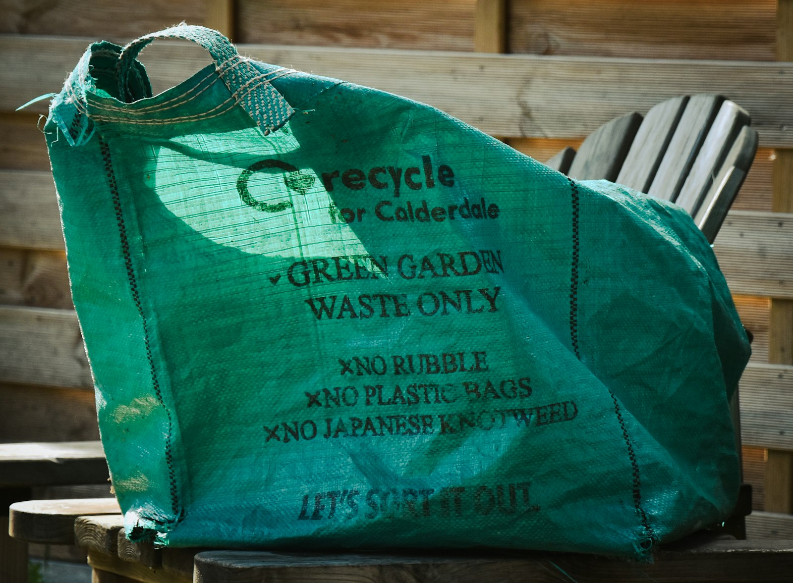 Green garden waste bag ready for collection