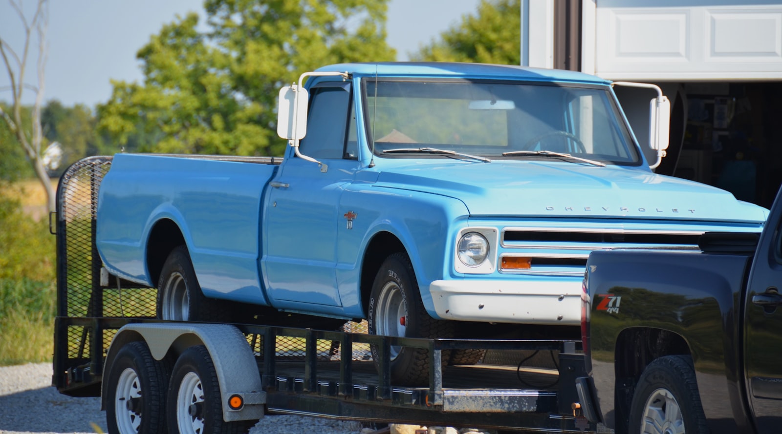Classic pickup truck on a trailer, ready for a rubble removal or moving job